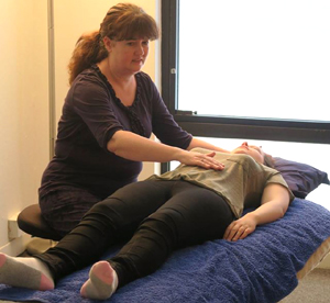 Photo of Elaine giving a client Reiki